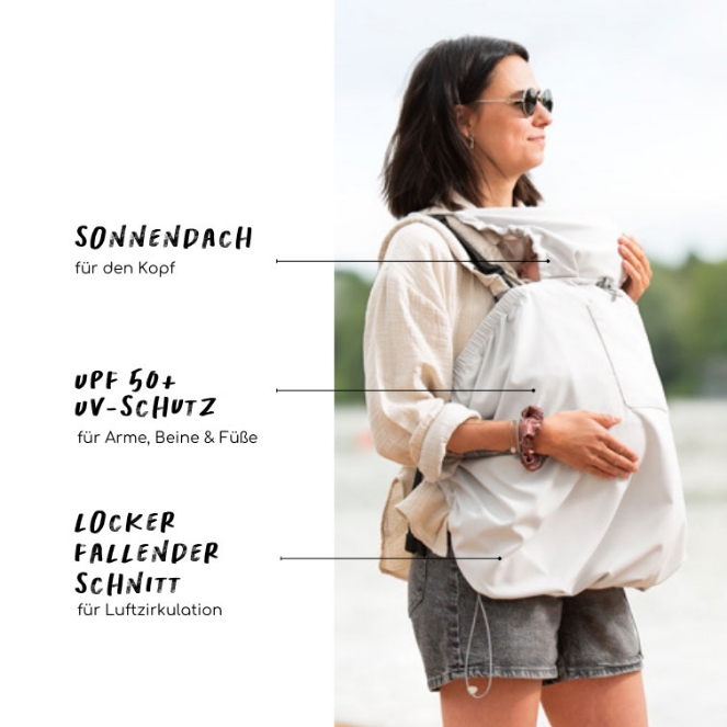 Eine Frau trägt ihr Baby mit einem weißen Tragetuch von mamalila an ihrer Brust.